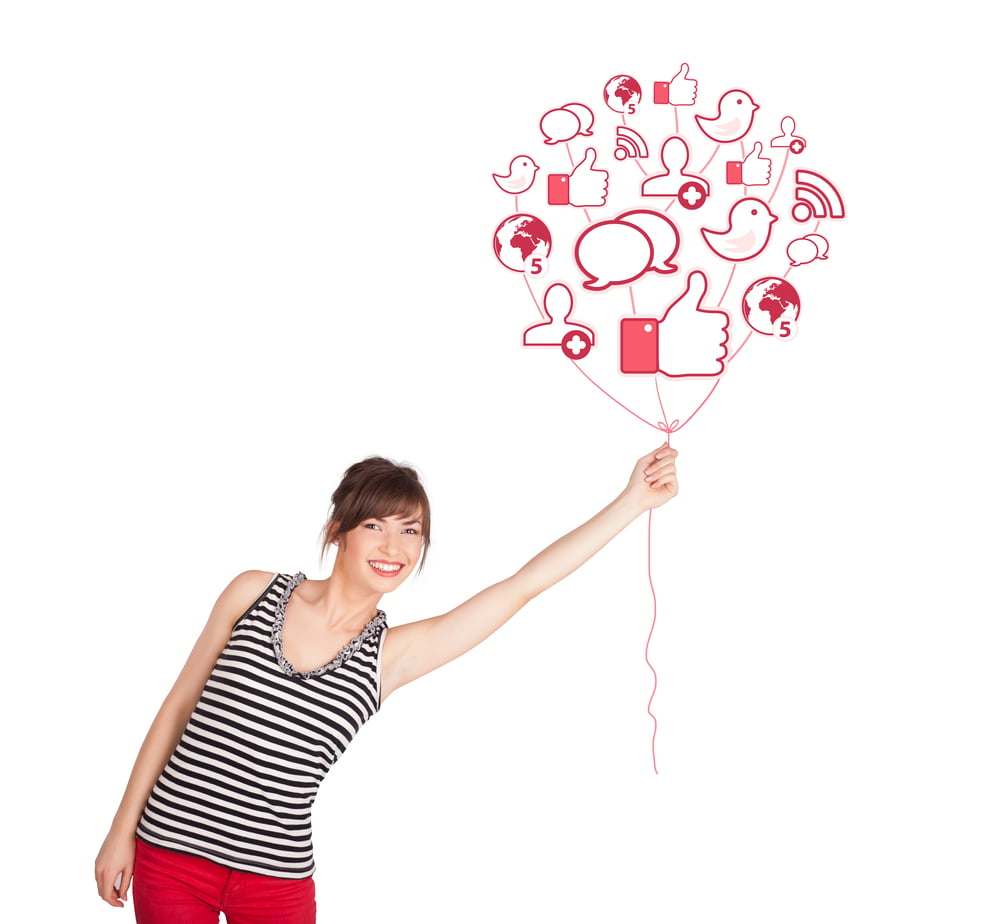 Happy young lady holding social icon balloon